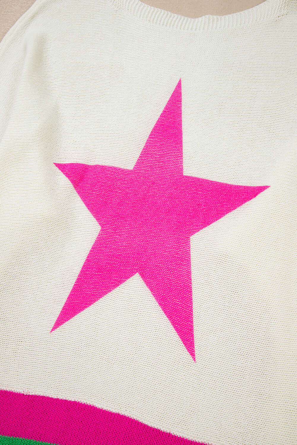 STARSTRUCK SWEATER featuring a bold pink star design on a soft, colorblock knit fabric.