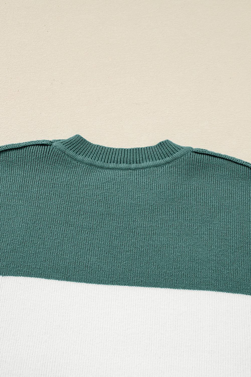 Back view of the MOUNTAIN AIR SWEATER showing the ribbed knit and color block design.