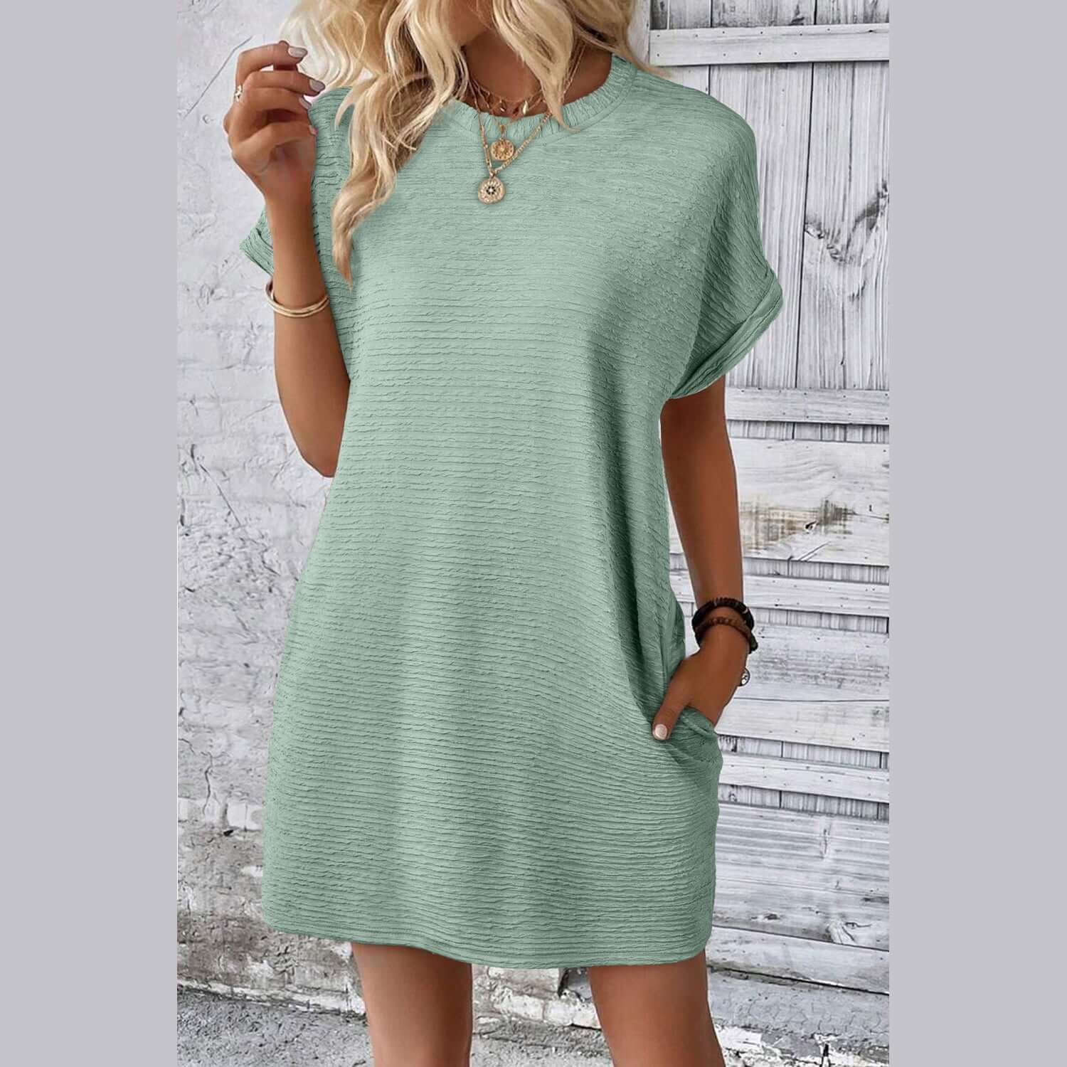 Sage green crinkle textured shift dress with pockets, perfect for casual sunny day wear.