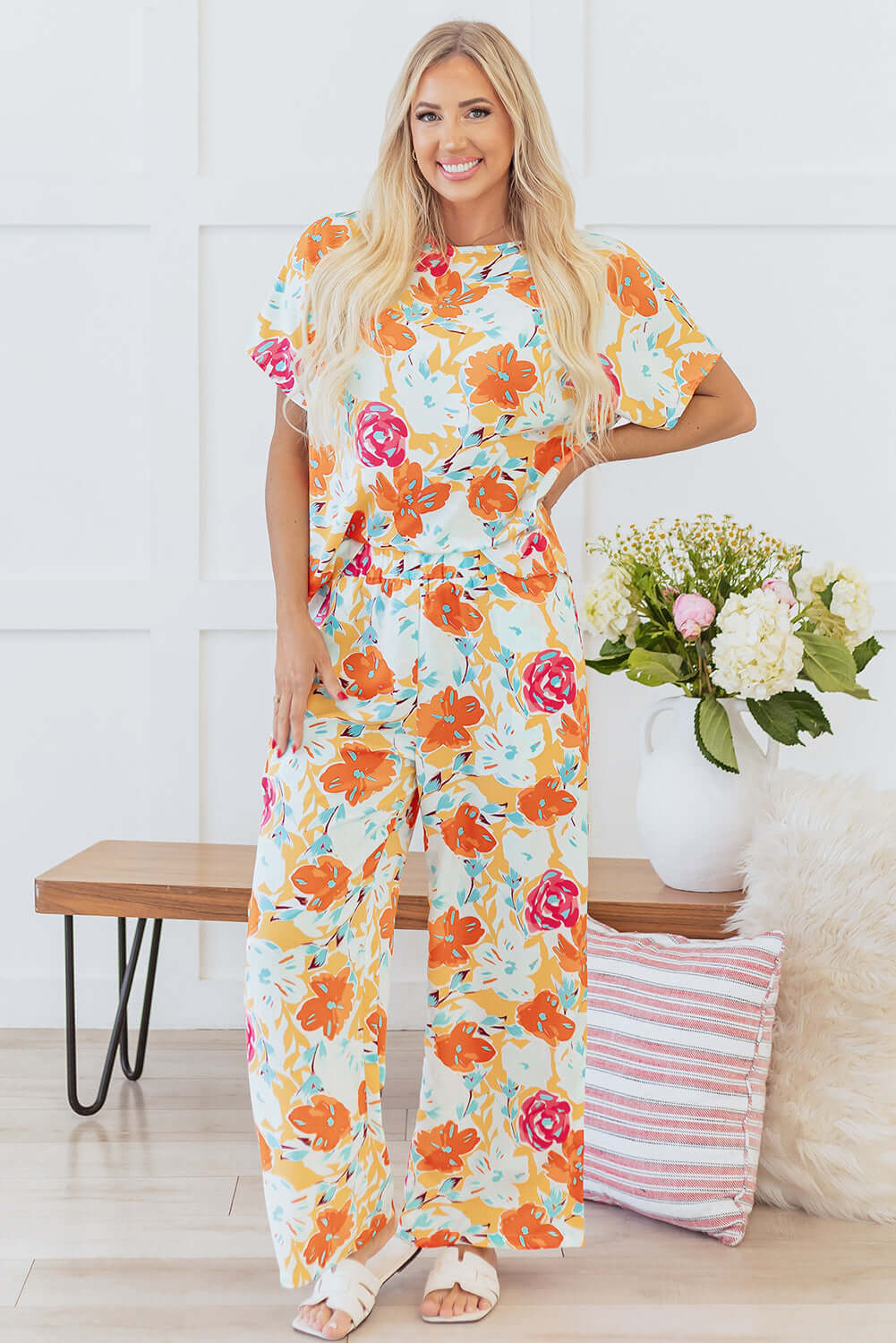 Sunset Stroll Pants Set featuring a floral short-sleeve top and wide-leg pants in tangerine and coral hues.