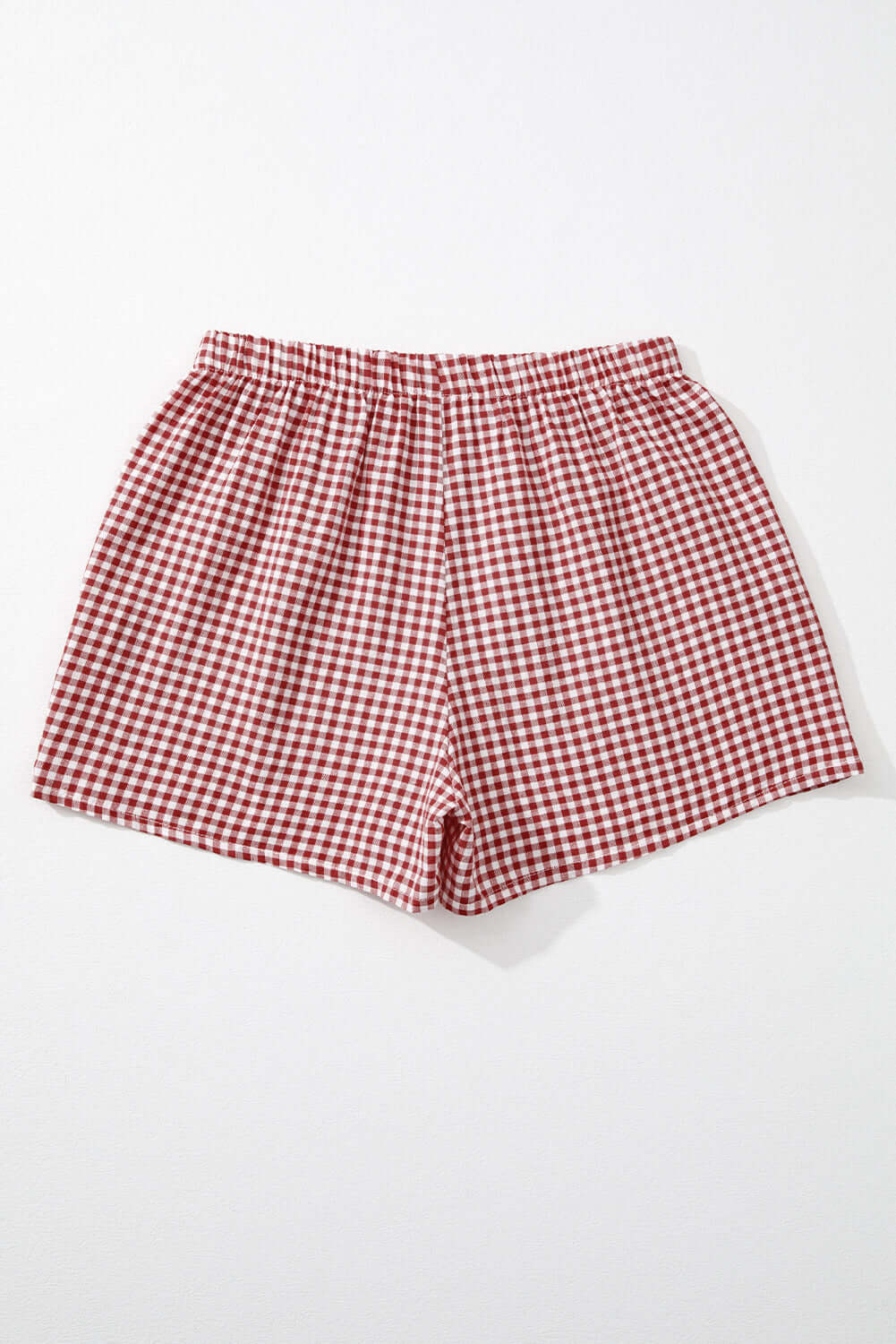 Red gingham high waist shorts with elastic waistband for comfort and style, perfect for sunny picnics.