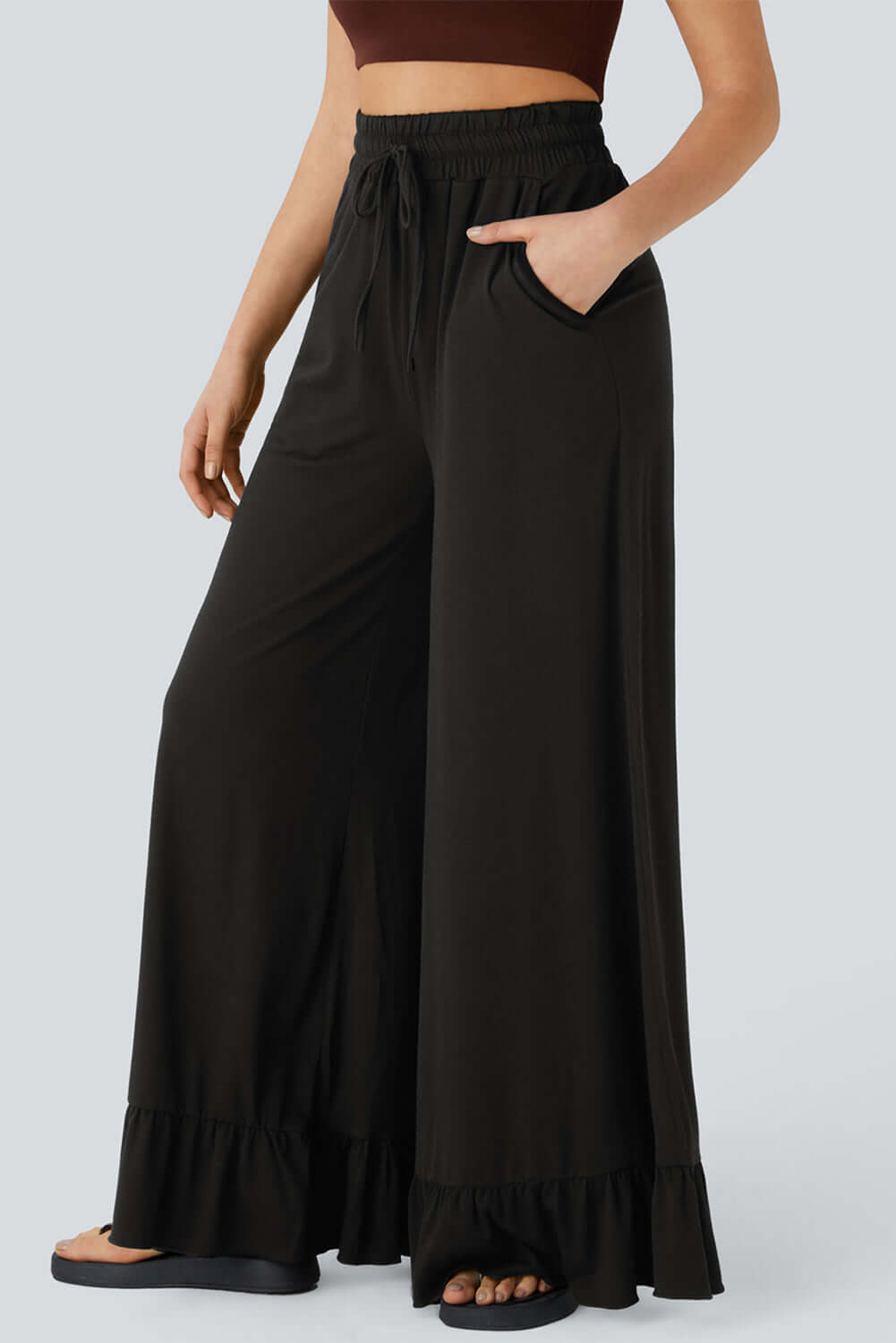 Charmed Comfort Wide Leg Pants in black with ruffled hem and pockets, perfect for stylish and comfortable outfits.