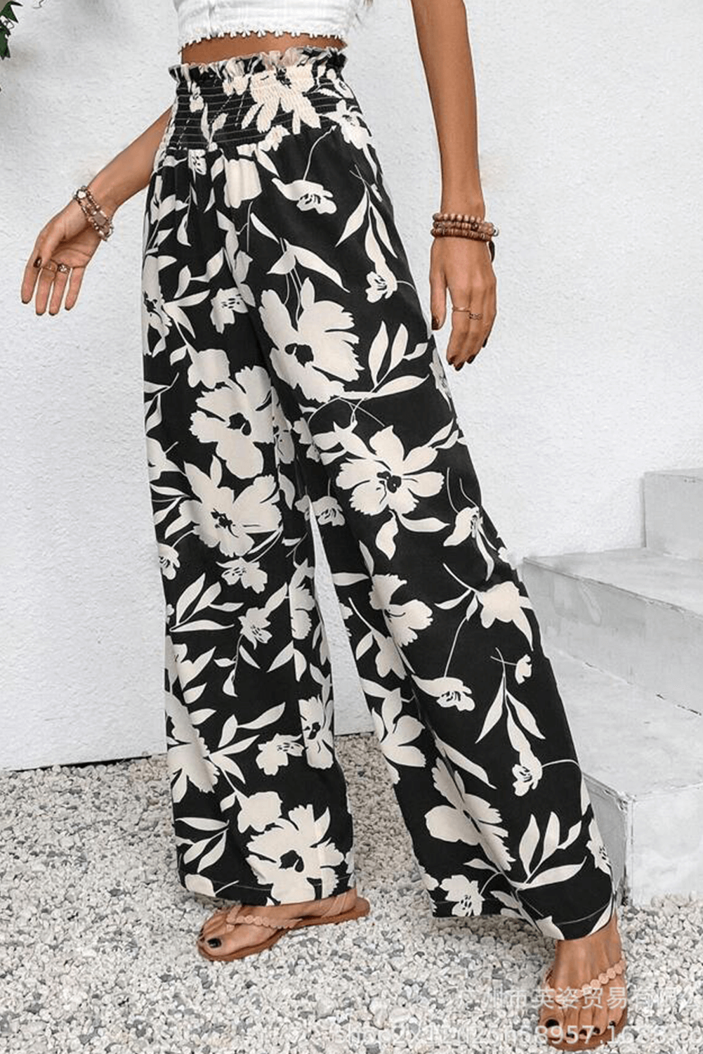 Evening Out Wide Leg Pants featuring a black floral print and smocked high waist for a chic boho look.