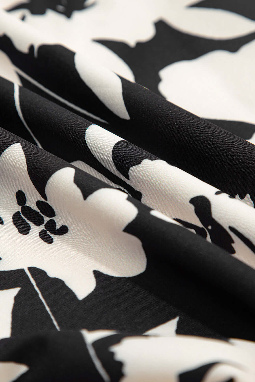 Close-up of the fabric showcasing the black floral print of EVENING OUT WIDE LEG PANTS.
