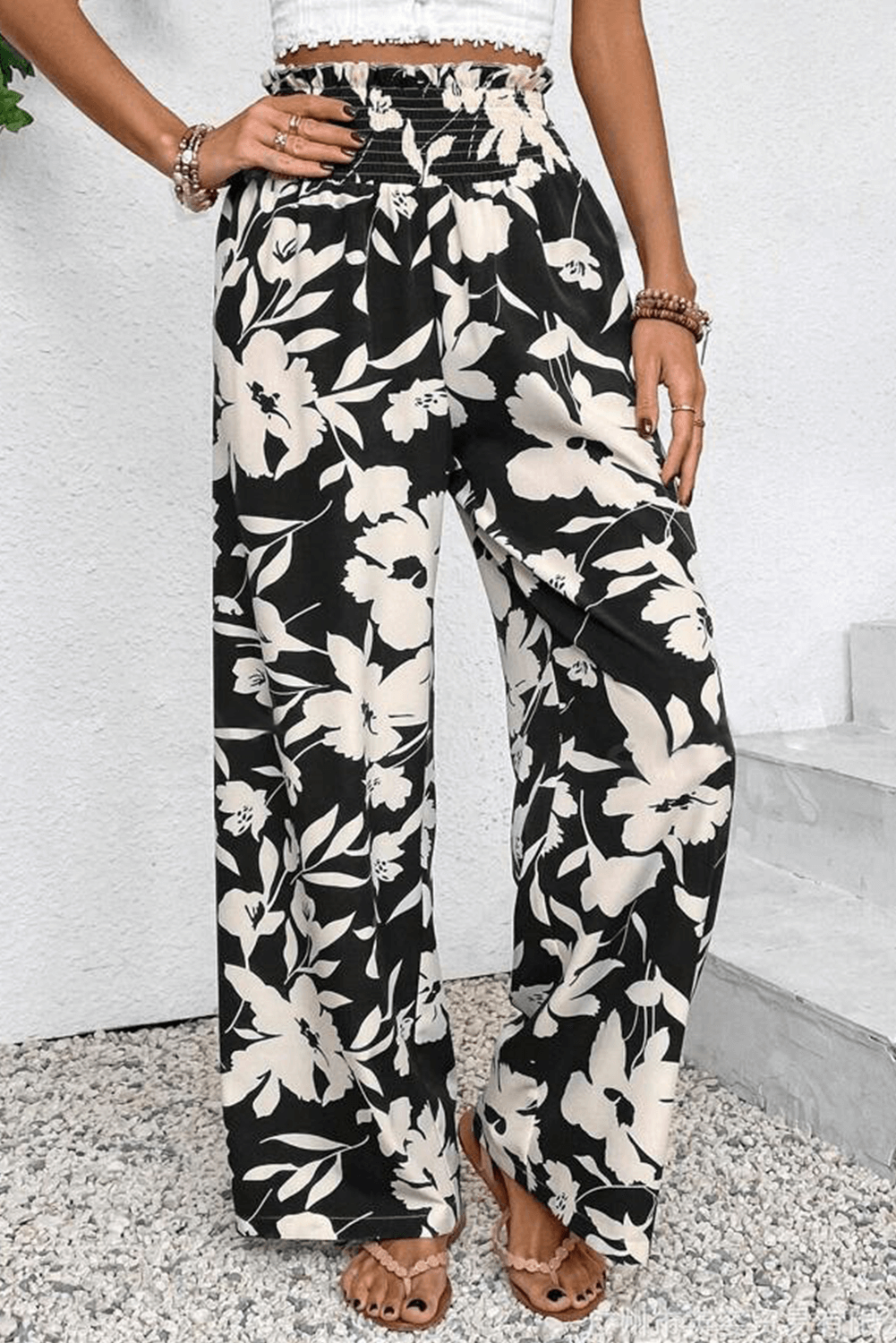 Stylish EVENING OUT WIDE LEG PANTS in black floral print, featuring smocked high waist and flowy silhouette.