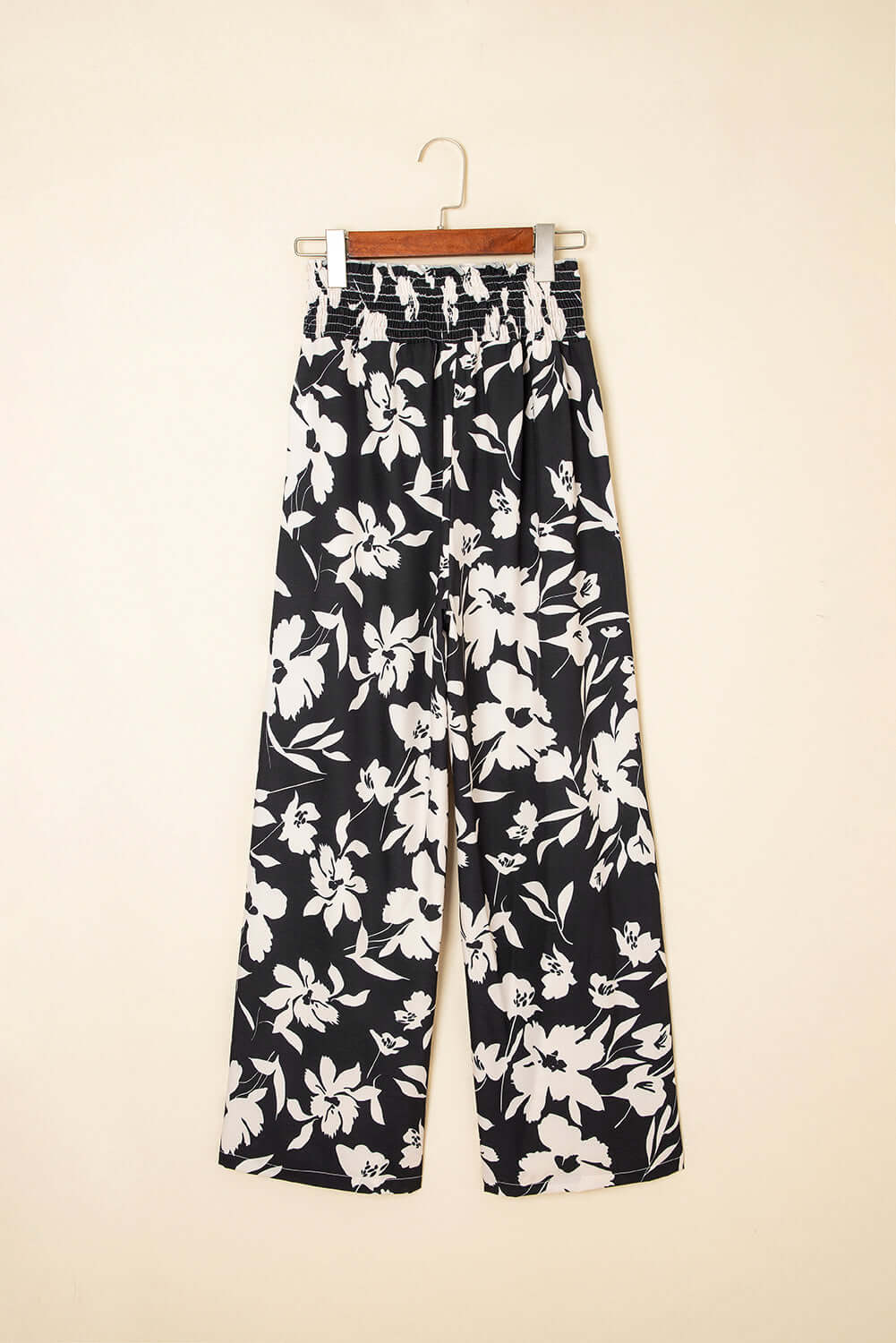 Stylish EVENING OUT WIDE LEG PANTS in black floral print, featuring a smocked high waist and flowy silhouette.