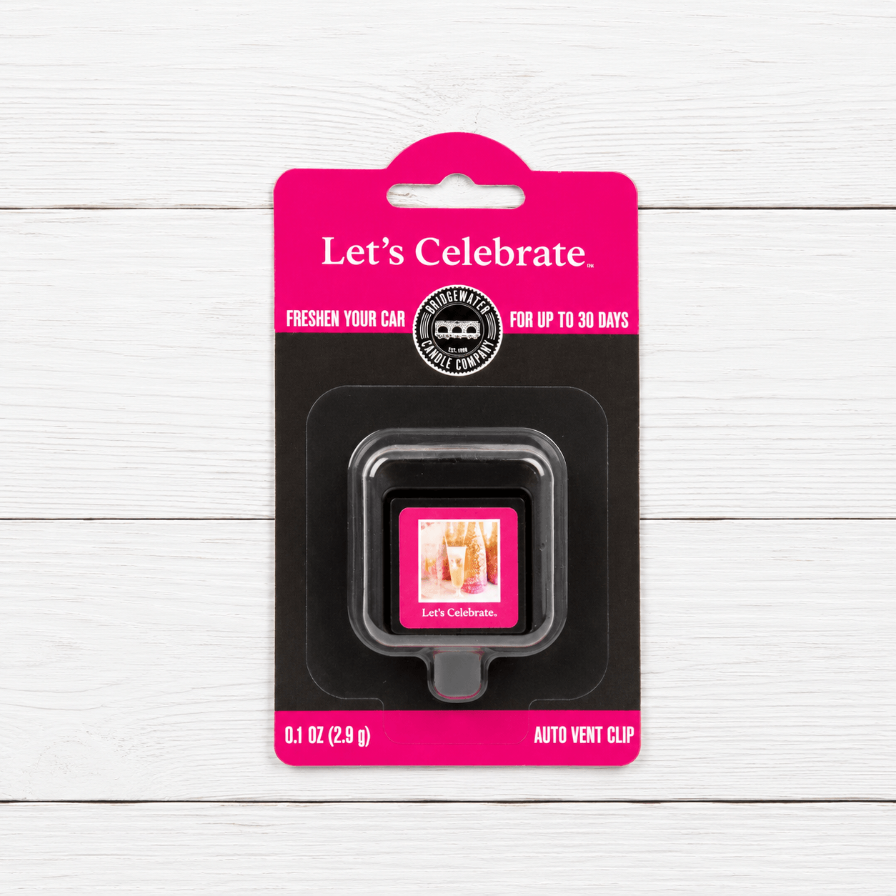 LET’S CELEBRATE VENT CLIP packaging by Bridgewater Candle Company on a wooden background.