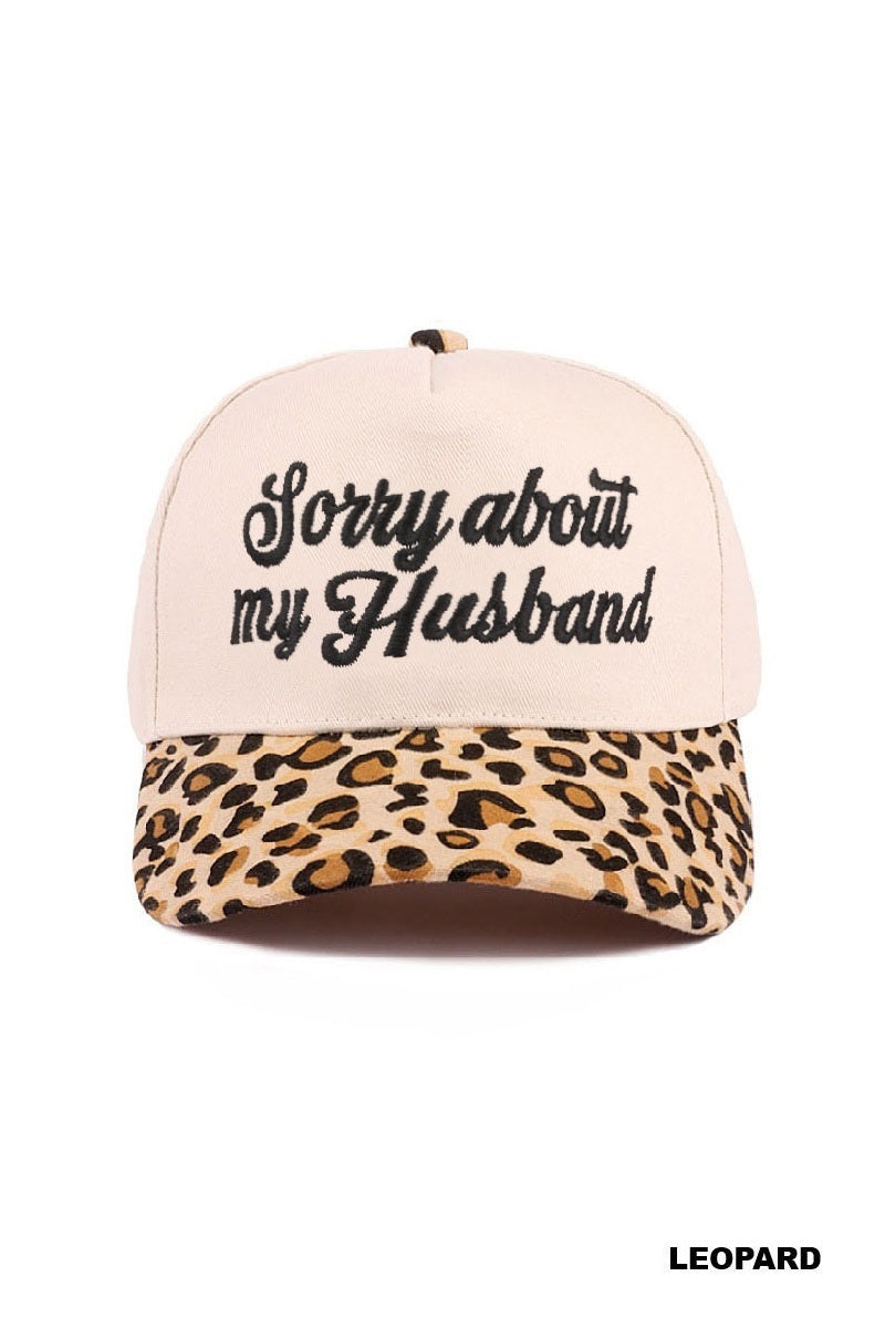 SORRY ABOUT MY HUSBAND HAT (6 colors) in leopard print with cream base and embroidered text.