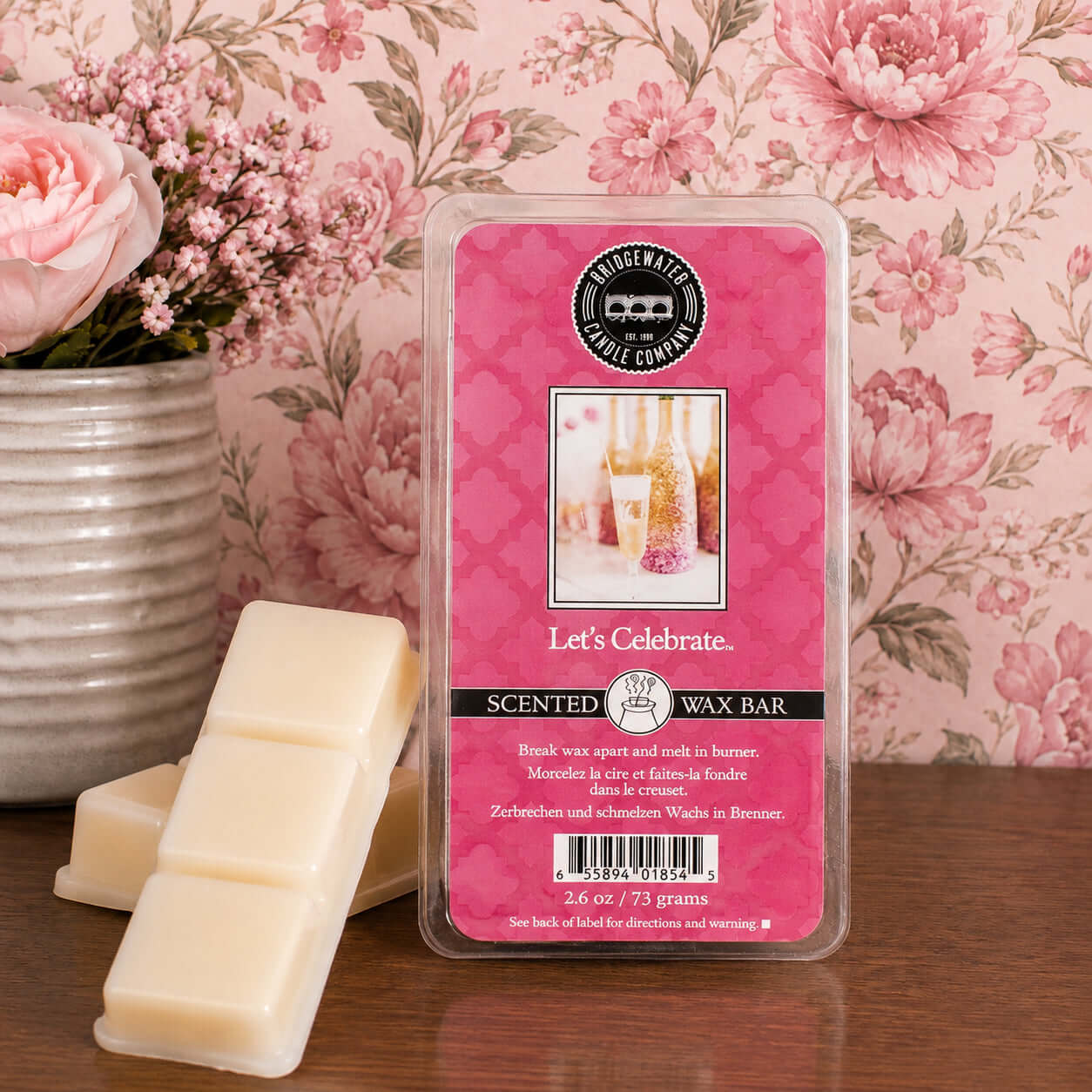LETS CELEBRATE WAX MELTS by Bridgewater Candle Company in pink packaging with wax cubes placed beside it.