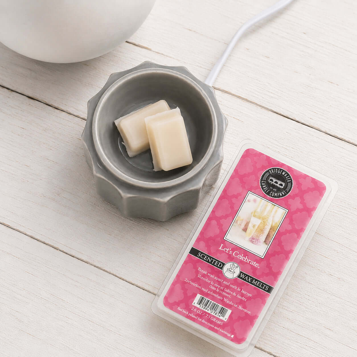 LETS CELEBRATE WAX MELTS in a gray wax warmer with wax bars by Bridgewater Candle Company.