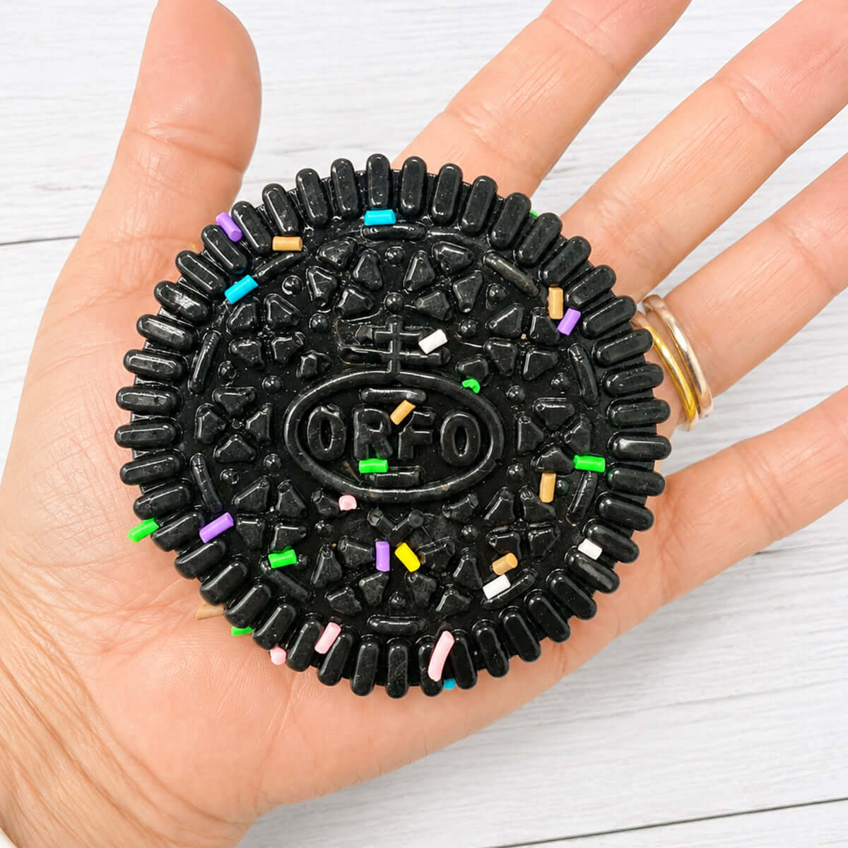 SANDWICH COOKIE SQUISHY in hand, featuring colorful sprinkles and a soft, squeezable texture for stress relief.