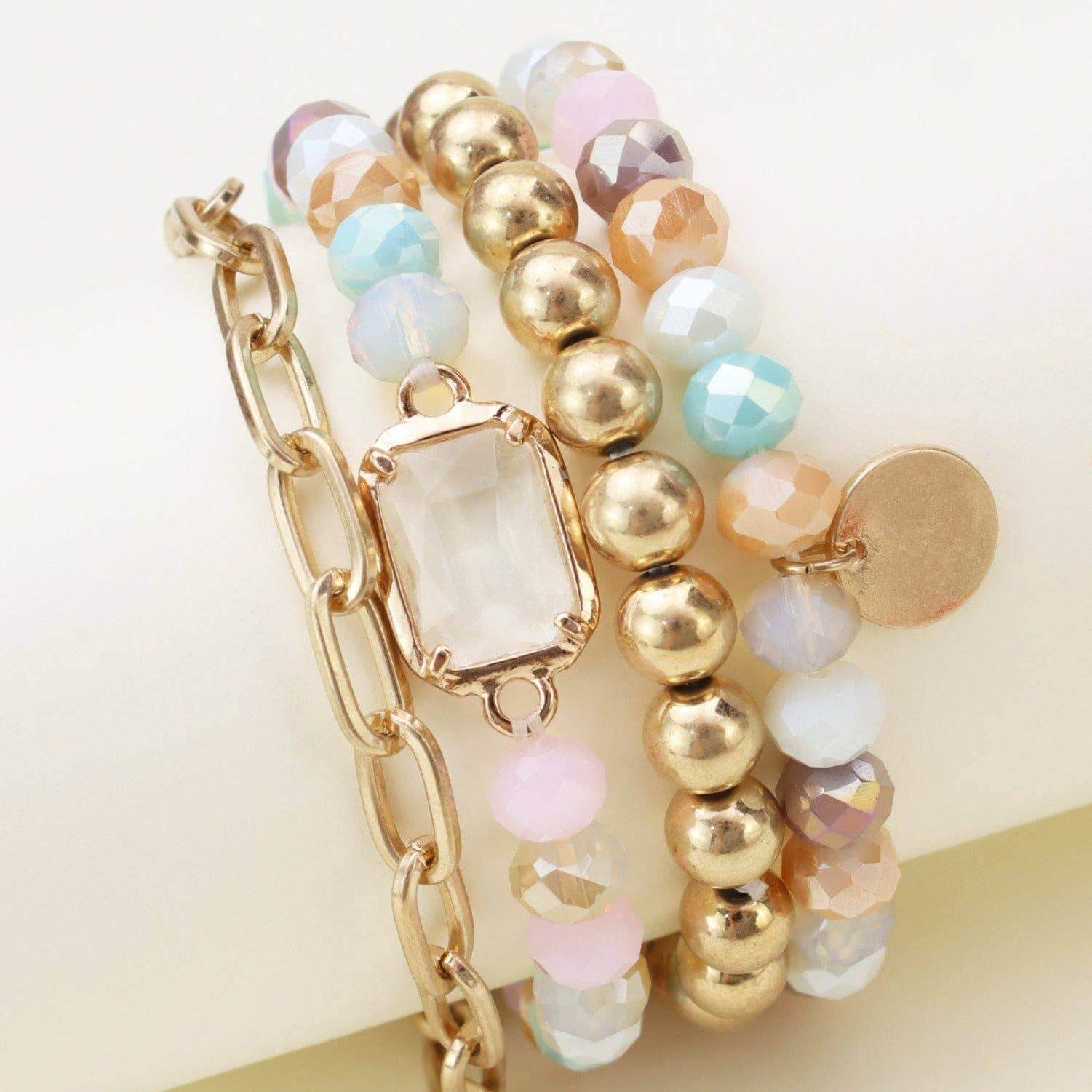 Prism Collection 4 piece bracelet set featuring multi-colored beads and a central gem for a stylish accessory.