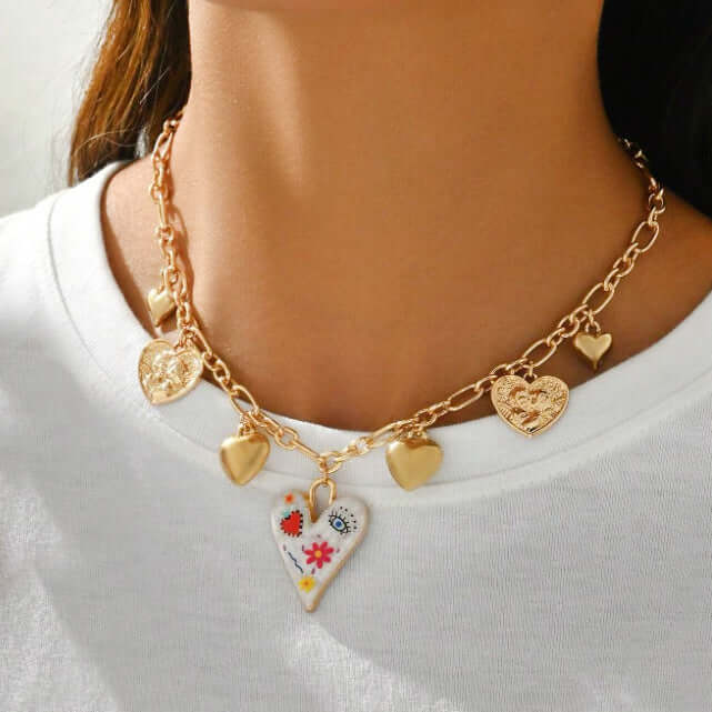PAINTED HEART CHARM NECKLACE featuring colorful heart locket and gold-tone charms, perfect for adding charm to any outfit.