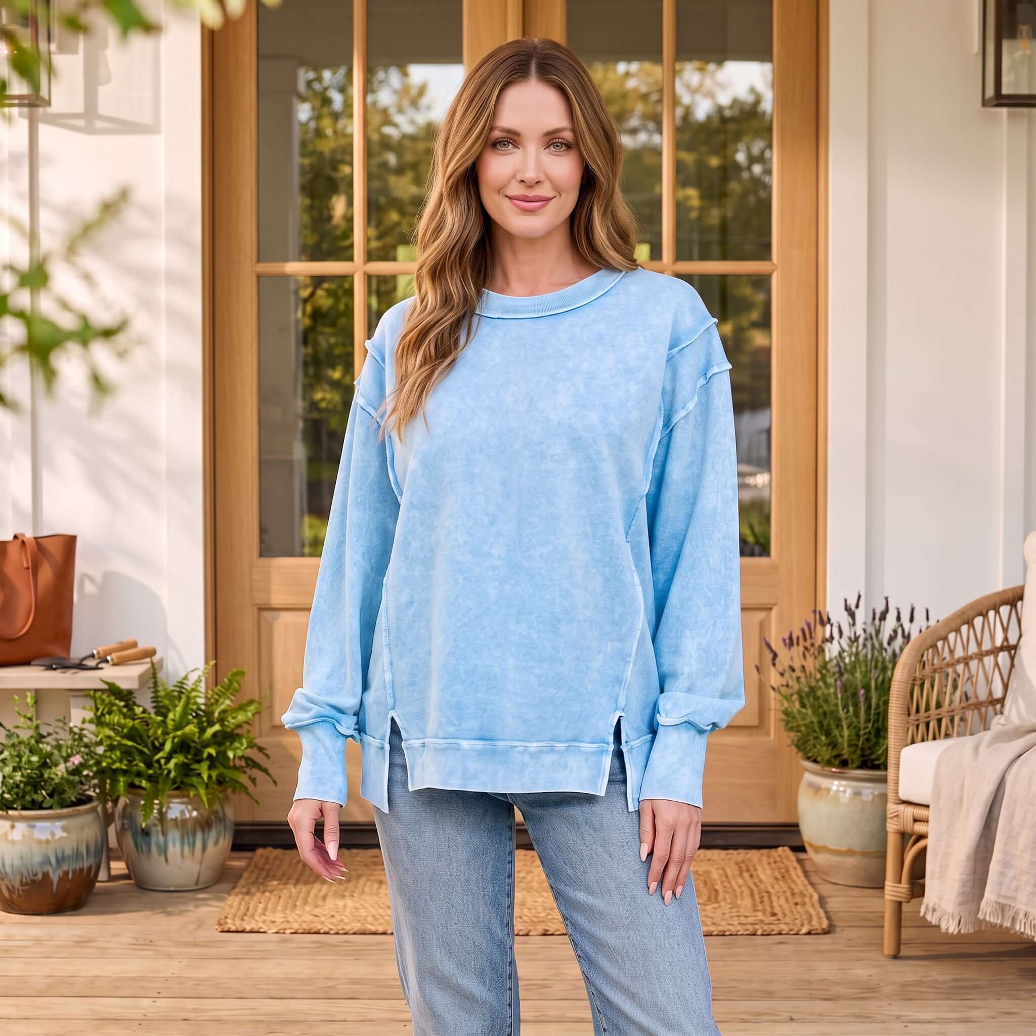WEEKEND COZY PULLOVER (3 colors) in blue, soft, relaxed fit French terry sweatshirt worn outdoors.