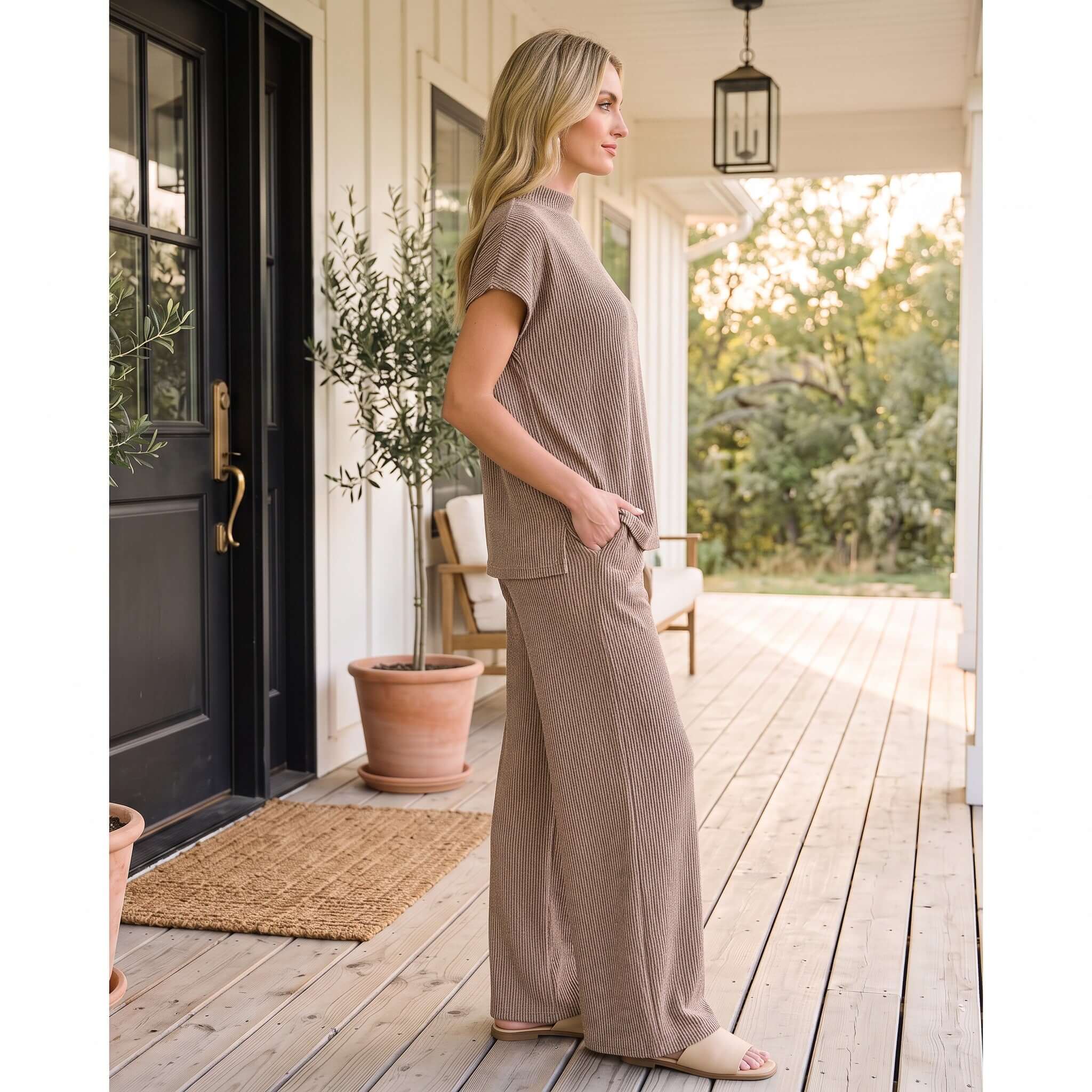 Woman in Bonfire Nights Pants Set (cocoa) standing on a porch, showcasing its cozy style and comfort.