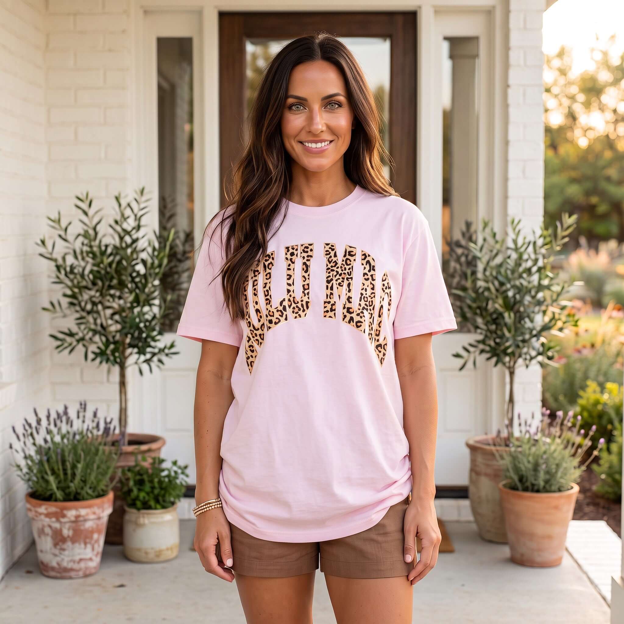 LULU MAC - Leopard/Pink Tee model wearing a pink tee with leopard print lettering, styled for a casual look.