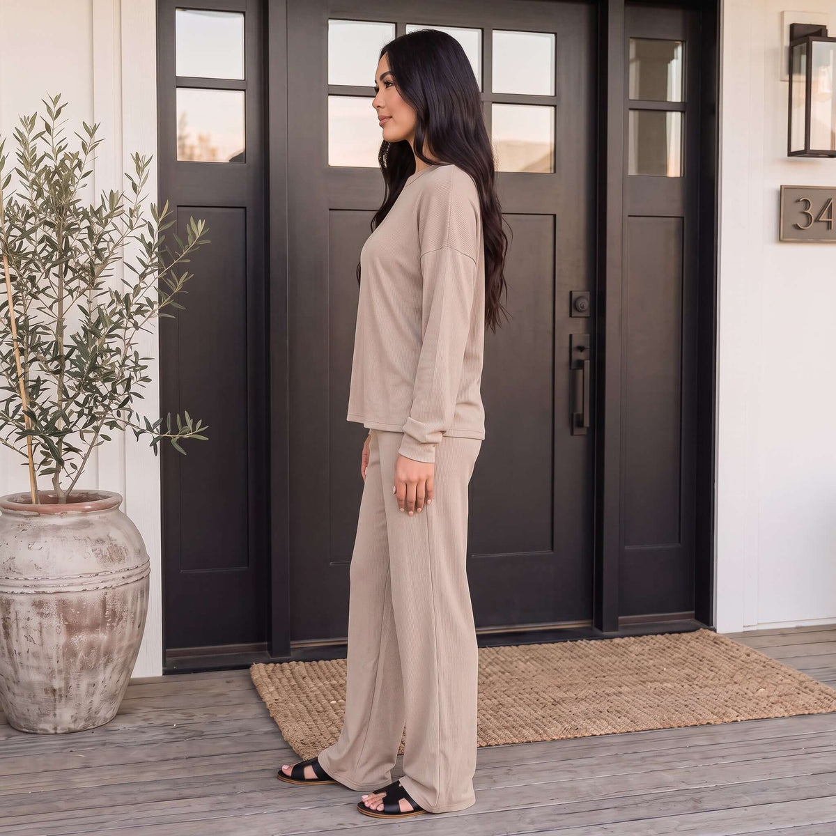 Model wearing SOFT LIFE PANTS SET (2 colors) in a relaxed style, showcasing comfort and elegance.