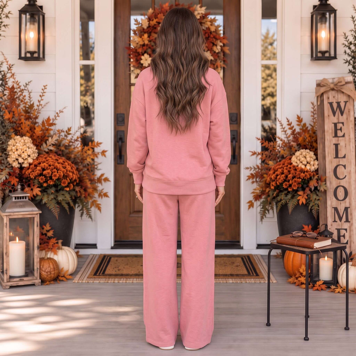 A woman wearing the BETTER TOGETHER SET in Light Rose stands at a welcoming front door surrounded by autumn decorations.