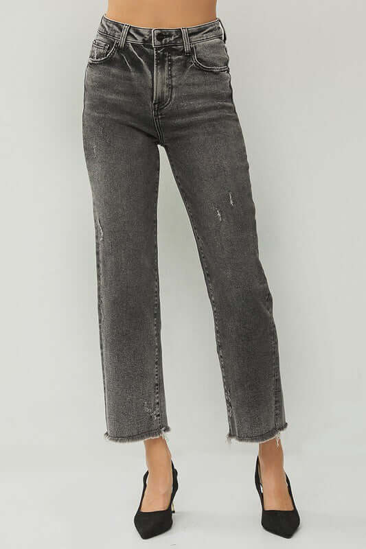 RISEN Veronica Jeans in acid wash black, featuring a high rise and frayed hem, styled with black heels.