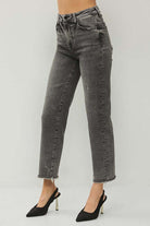 RISEN Veronica Jeans in acid wash black with frayed hem, styled elegantly with black heels.