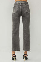 Back view of RISEN Veronica Jeans in acid wash black with frayed hem and high rise fit.