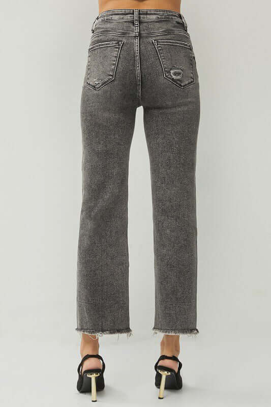 Back view of RISEN Veronica Jeans in acid wash black with frayed hem and high rise fit.