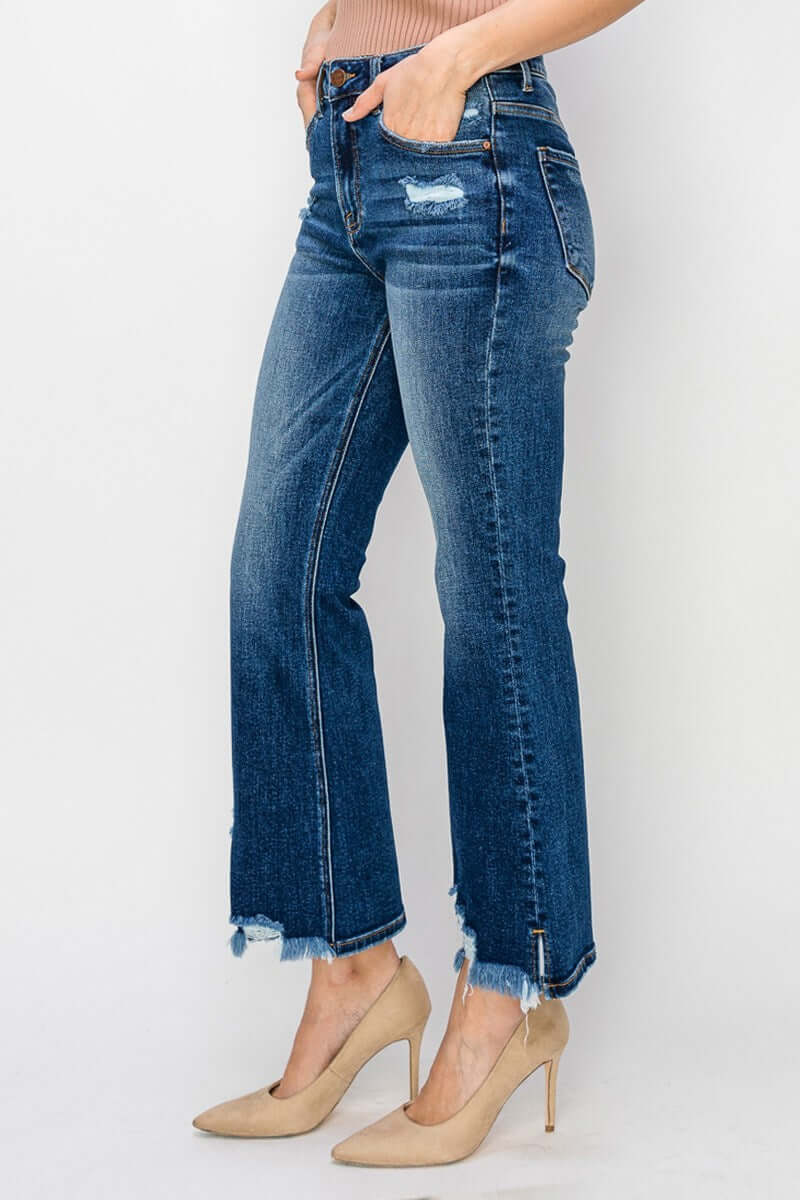 Side view of RISEN Marley Jeans, featuring dark wash, flattering flare cut, and stylish distressing paired with heels.