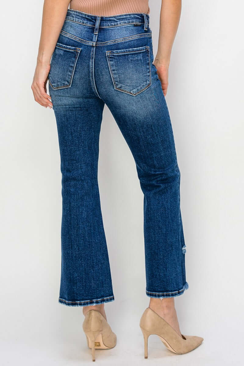 Back view of RISEN Marley jeans in dark wash with slight distressing, showcasing a flattering flare bottom.