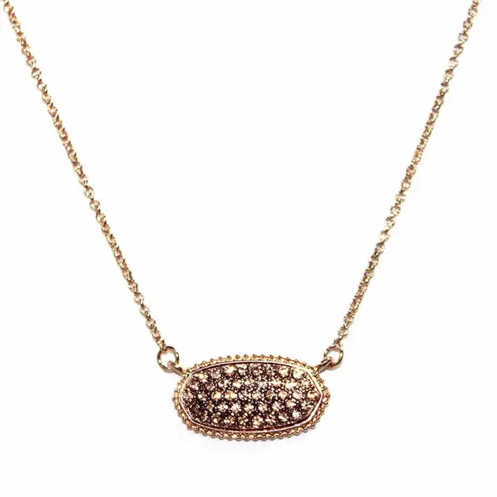 Druzy oval pendant necklace featuring textured stone on a delicate chain, perfect for elegant styling.