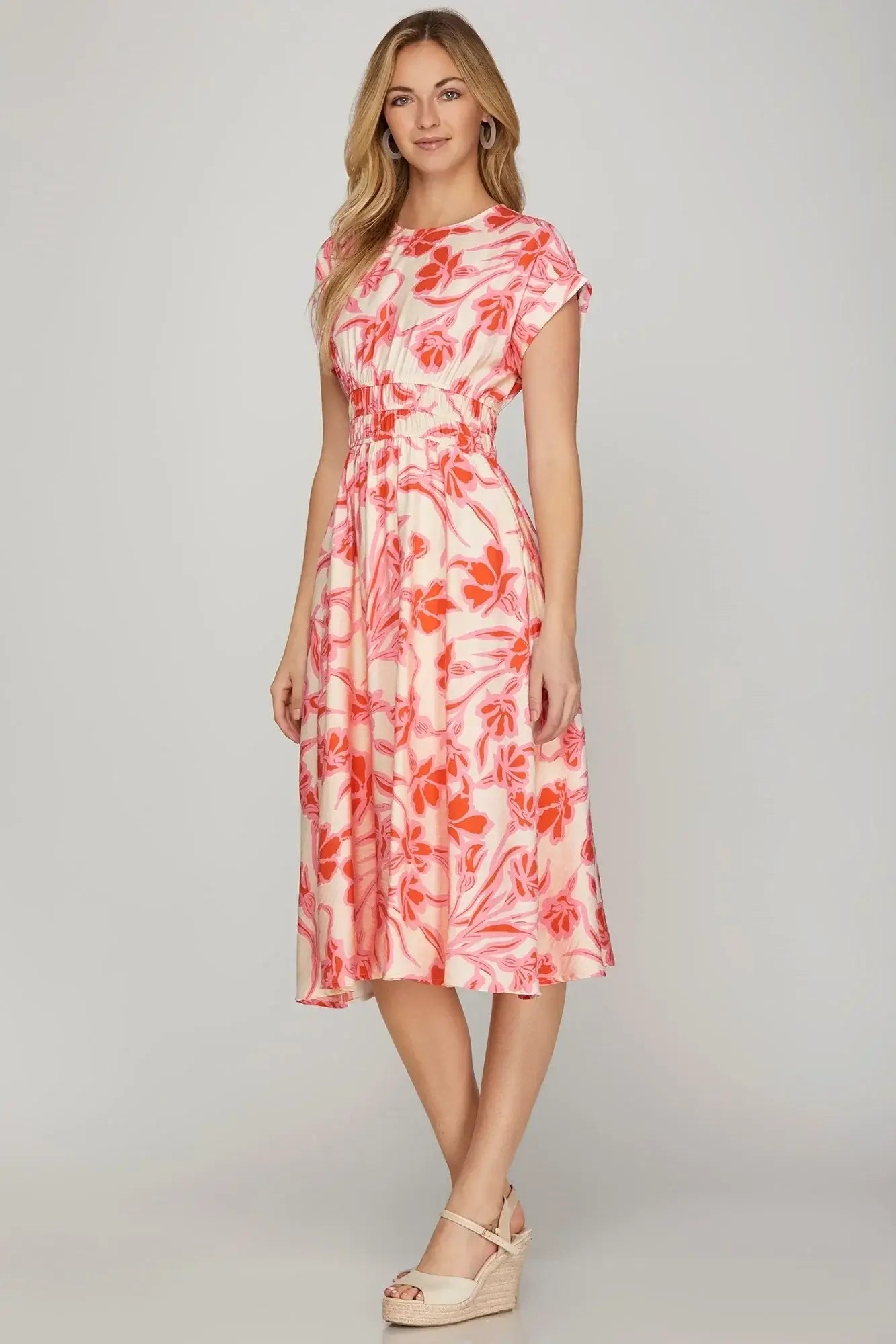 Model wearing the PAPAYA PARADISE DRESS by She + Sky, featuring a vibrant floral design and relaxed silhouette.