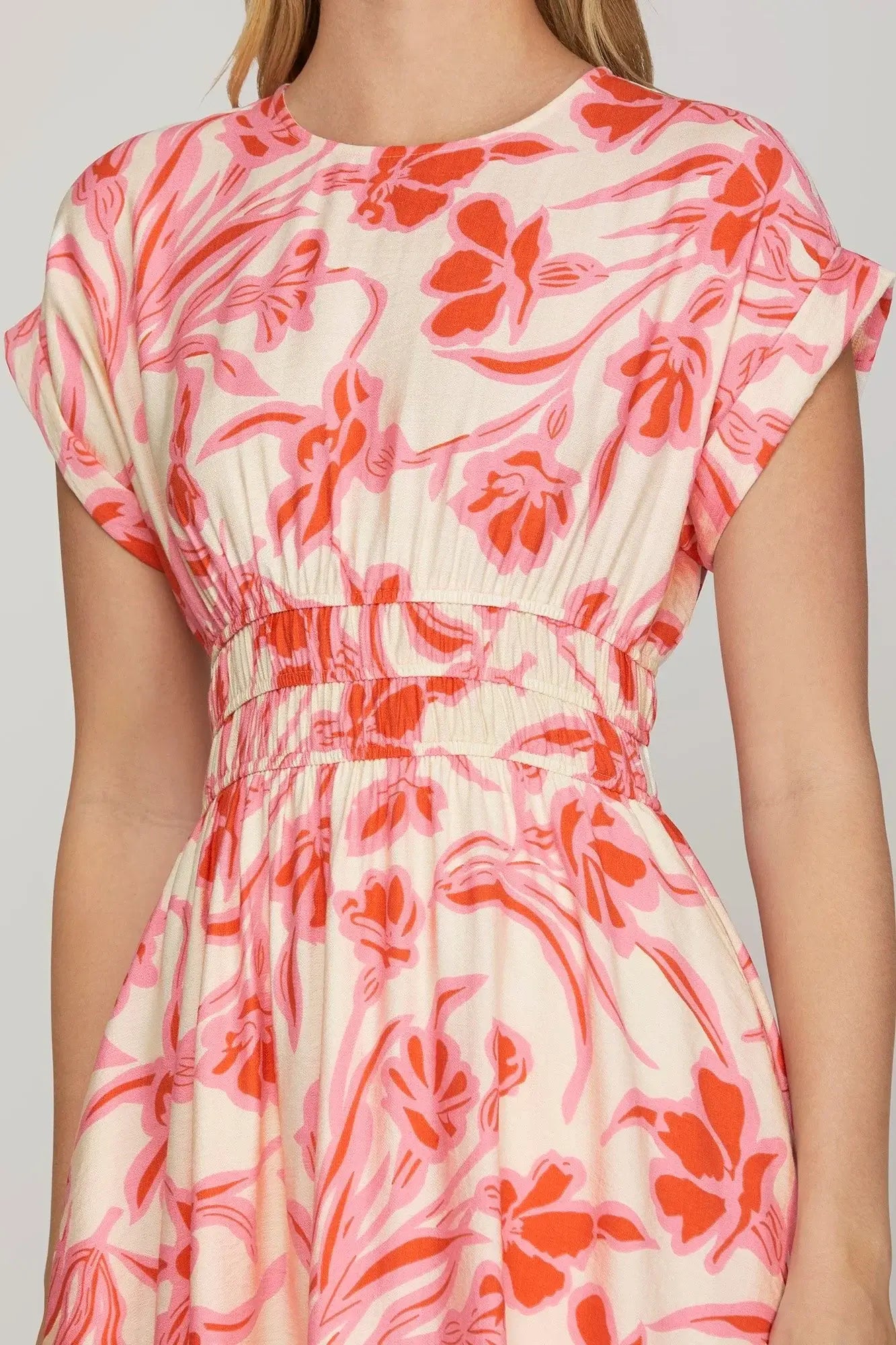Close-up of the Papaya Paradise Dress by She + Sky, featuring a floral print and cinched elastic waistband.