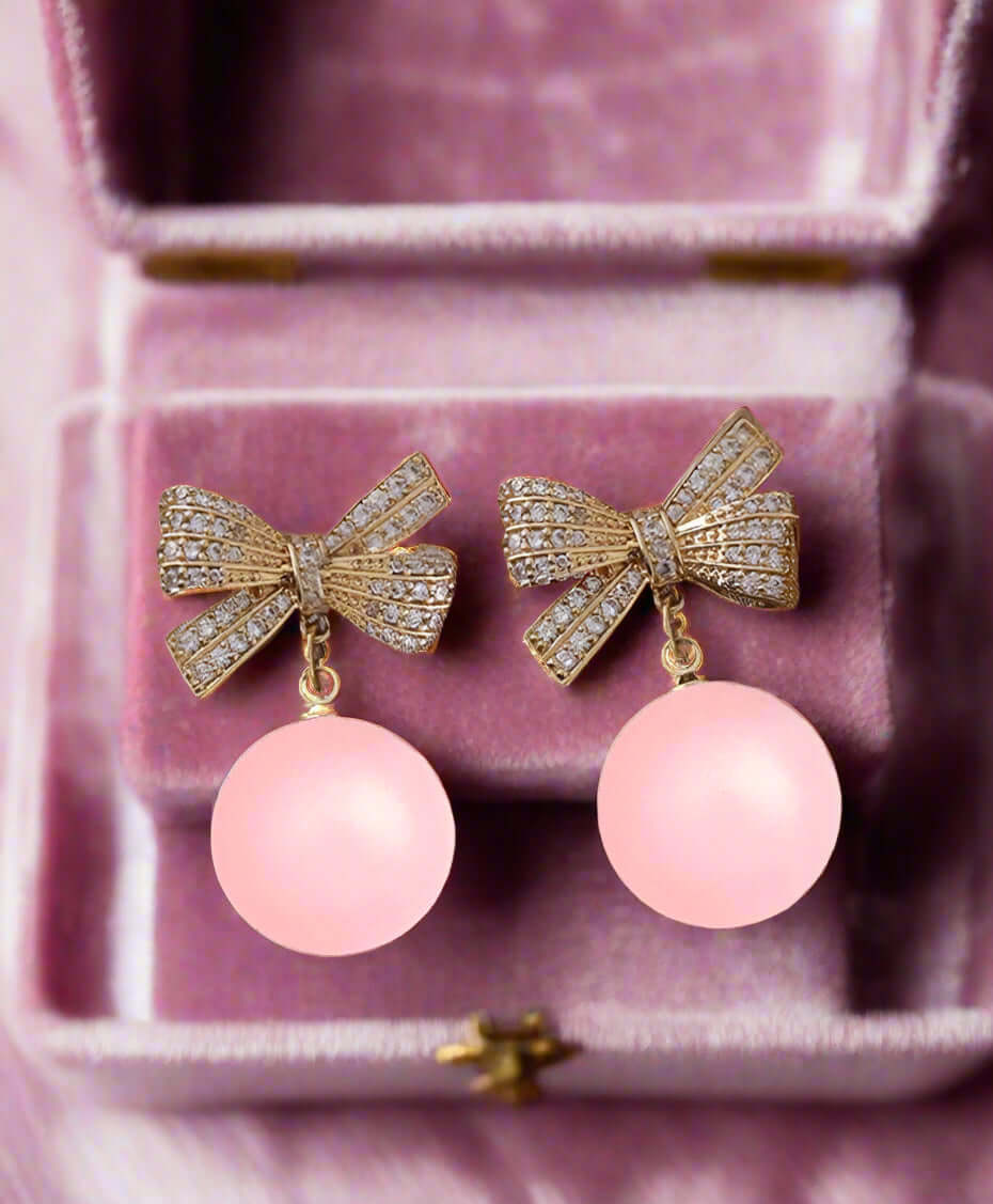 LACED ATMO-SPHERE EARRINGS with rhinestone bows and cool pink spheres in velvet box.