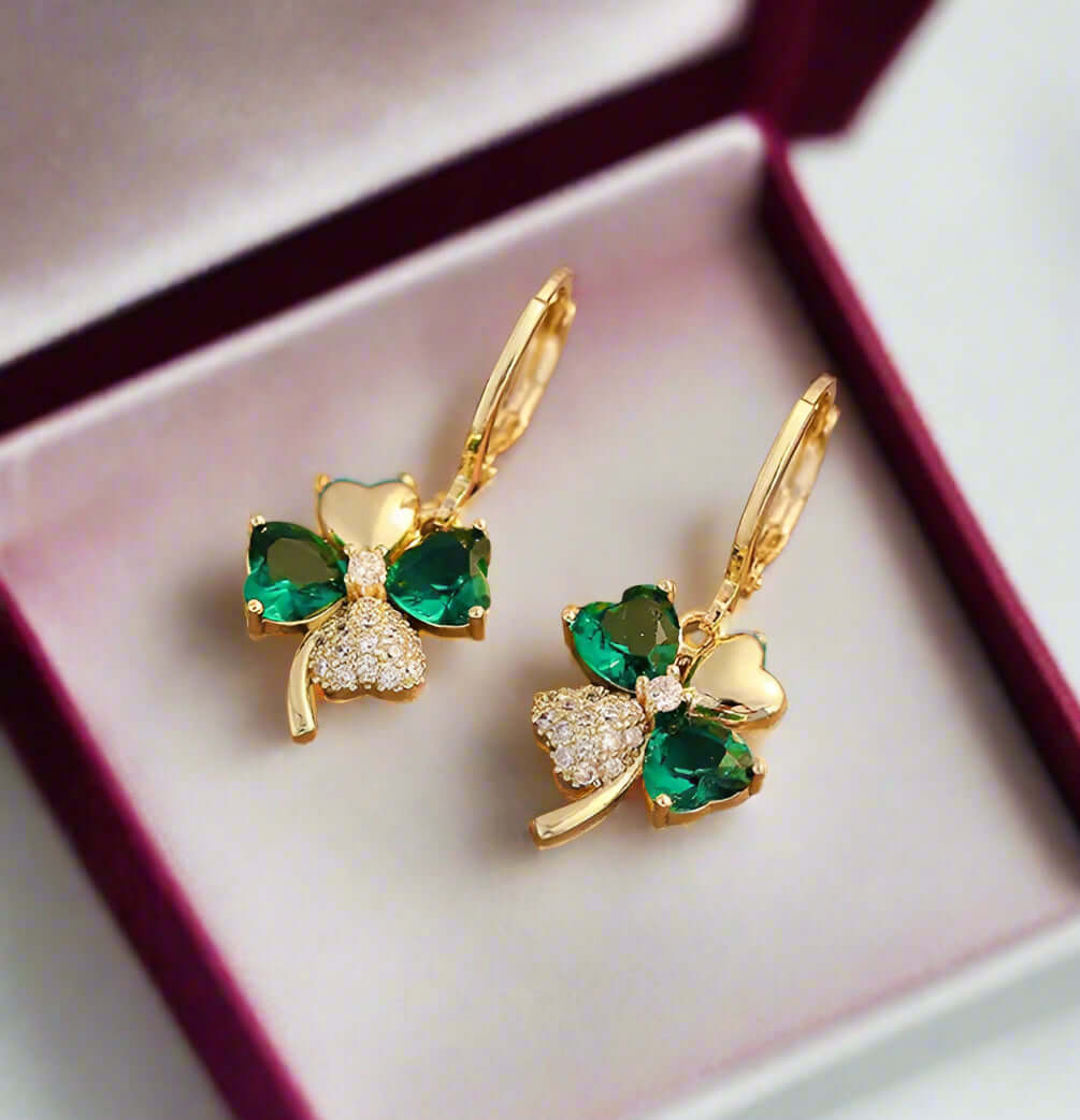 So Lucky Earrings featuring a gold-tone 4 leaf clover with green faux gemstones and sparkling rhinestones.