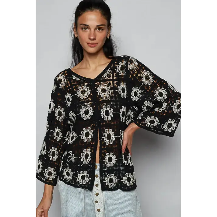 Black Dahlia Top featuring intricate black crochet design with ivory flowers, perfect lightweight layer for stylish outfits.