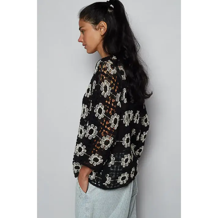 Side view of Black Dahlia cardigan featuring intricate floral embroidery on open crochet design.