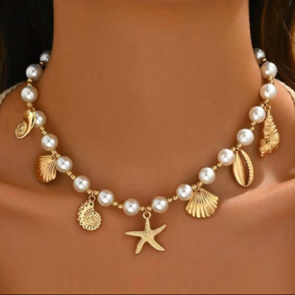 Seaside Glam Charm Necklace featuring pearl beads and gold seashell charms, ideal for a beachy boho look.