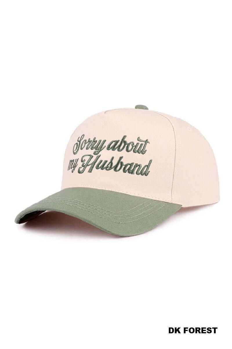 SORRY ABOUT MY HUSBAND HAT (6 colors) in cream and olive green, featuring embroidered text for a fun, sassy look.
