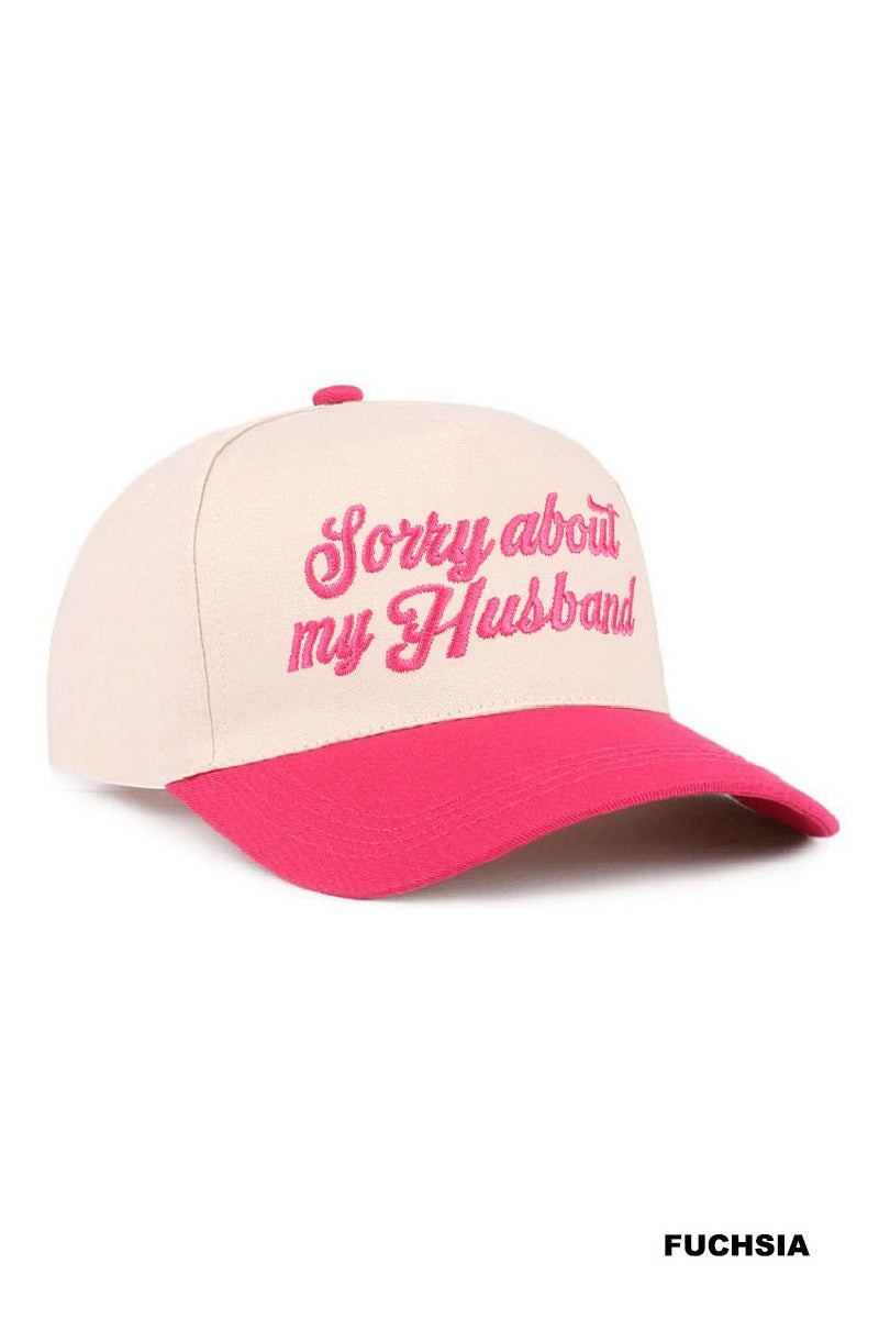 SORRY ABOUT MY HUSBAND HAT (6 colors) in fuchsia with embroidered script on a cream base.