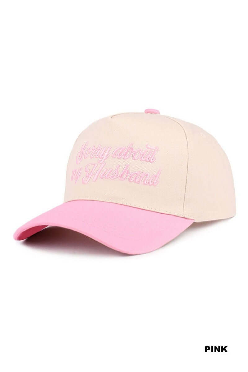 SORRY ABOUT MY HUSBAND HAT (6 colors) featuring a cream base and pink bill, perfect for a fun, cheeky accessory.