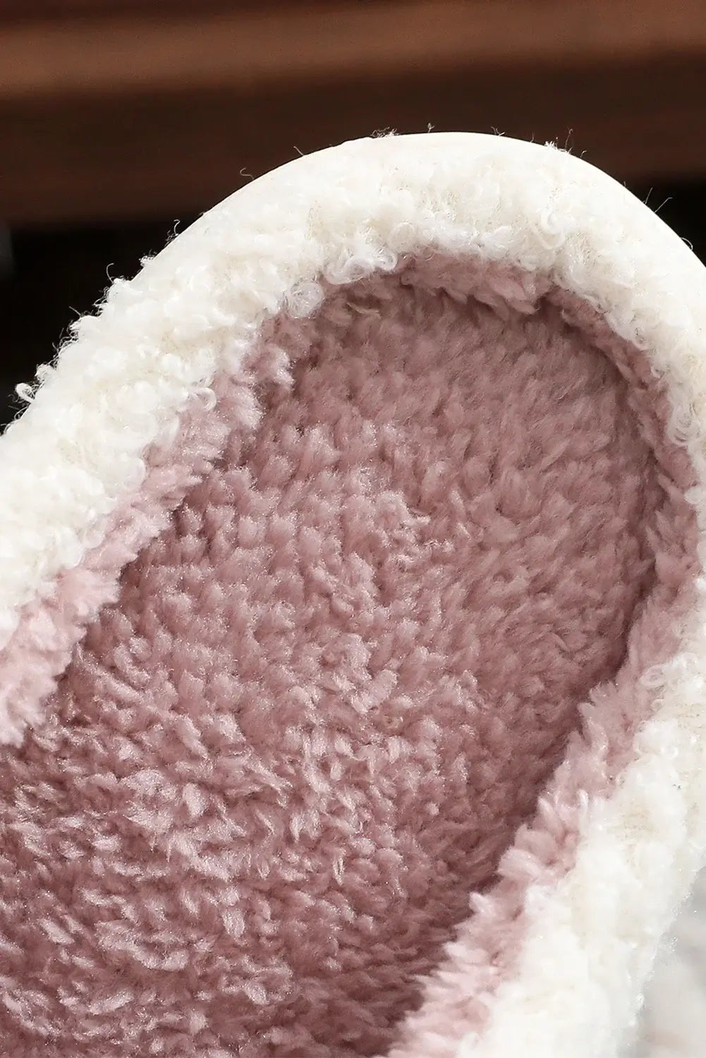Interior view of SWEET RETREAT BOW SLIPPERS showcasing soft sherpa lining and plush texture for ultimate comfort.
