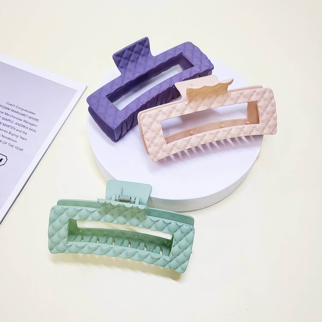 Everyday Luxe XL Hair Clips in purple, pink, and green with embossed quilted texture on a display.