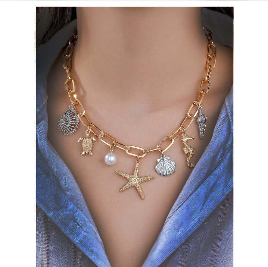 BEACHCOMBERS PARADISE CHARM NECKLACE with starfish, turtle, pearl, seahorse, and seashell charms.