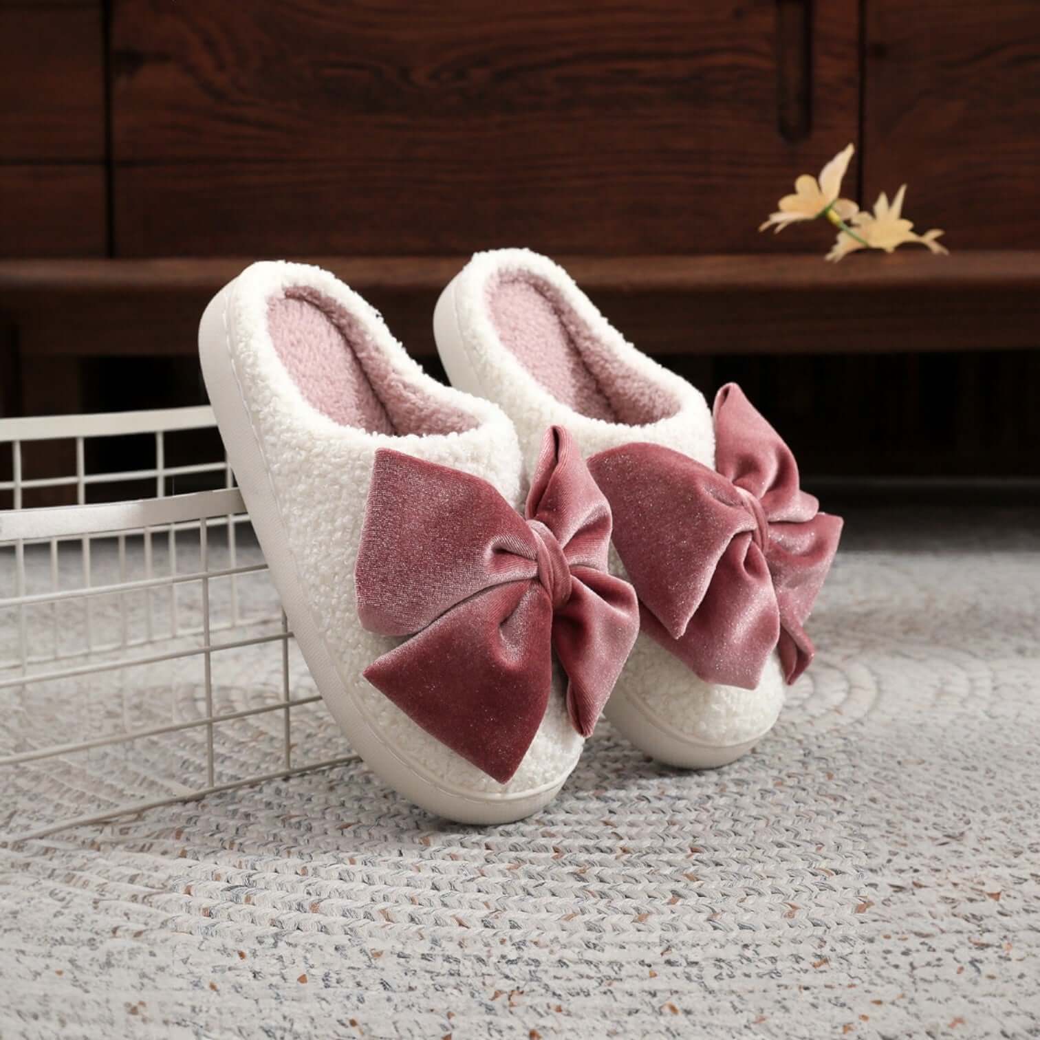 SWEET RETREAT BOW SLIPPERS featuring plush sherpa exterior and oversized velvet bow for cozy winter lounging.