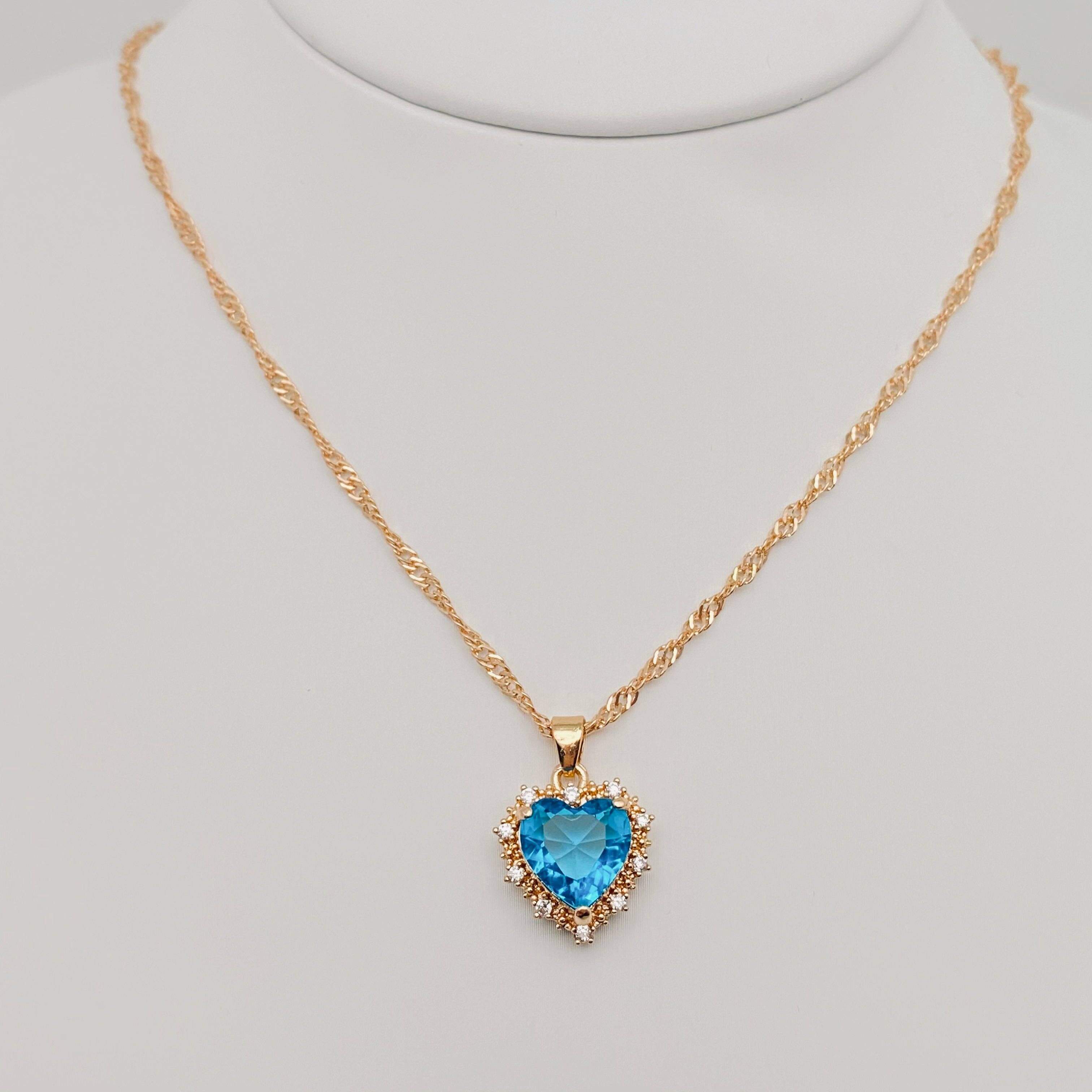 Heart-shaped Pendant Necklace Inlaid Cubic Zirconium with blue center and gold chain, perfect for adding sparkle to any outfit.