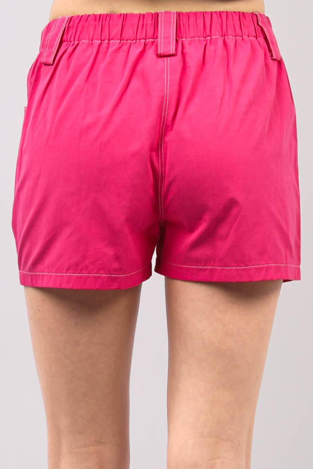 Back view of hot pink Play It Cool Shorts featuring an elastic waistband and relaxed fit for comfort.