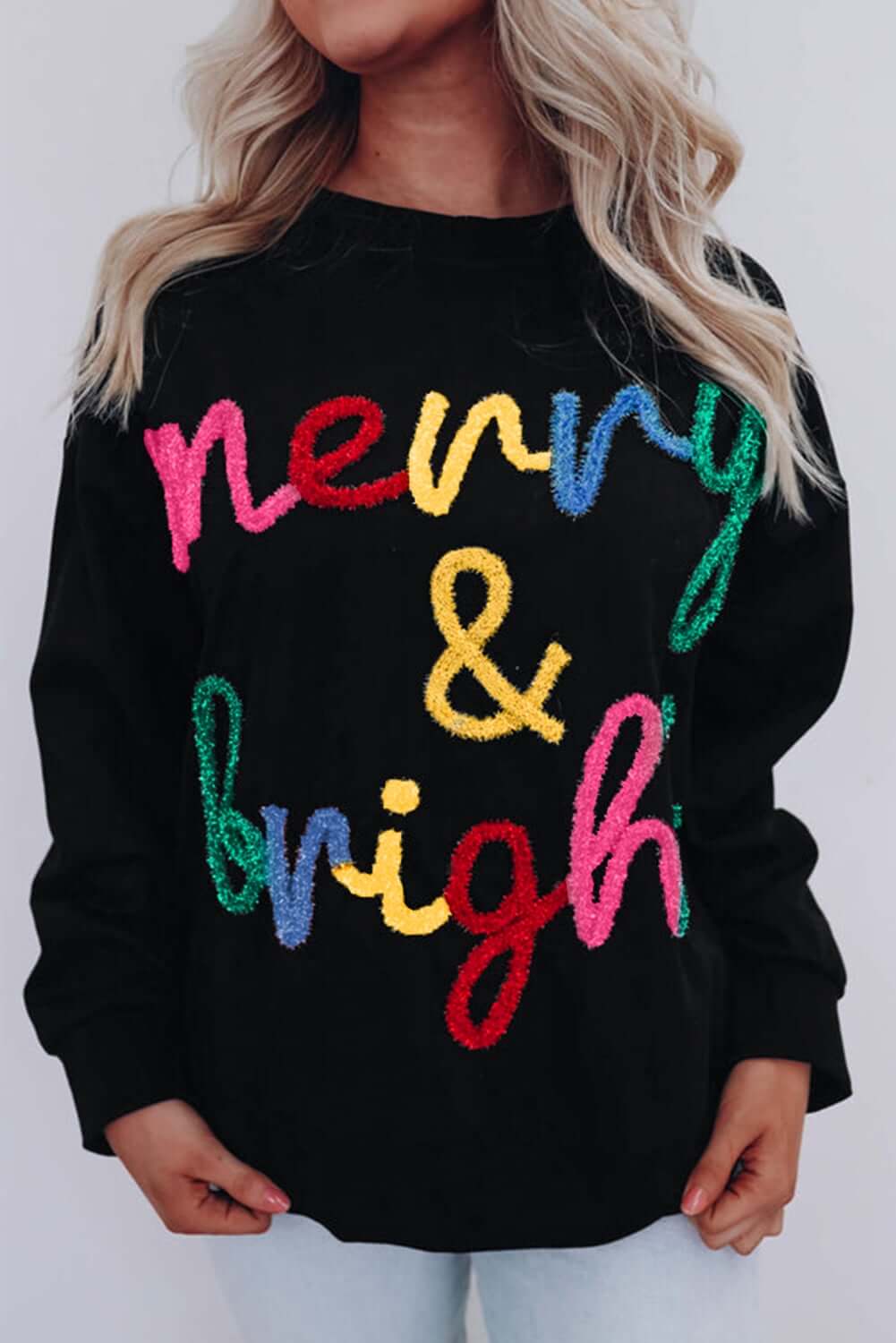 MERRY & BRIGHT SWEATER by Vivian-Lu featuring colorful tinsel letters on a black background, perfect for holiday celebrations.