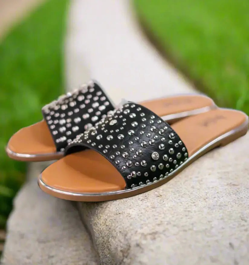 Corkys Bail Money sandals in black with studded wide straps, stylish and comfortable for any occasion.