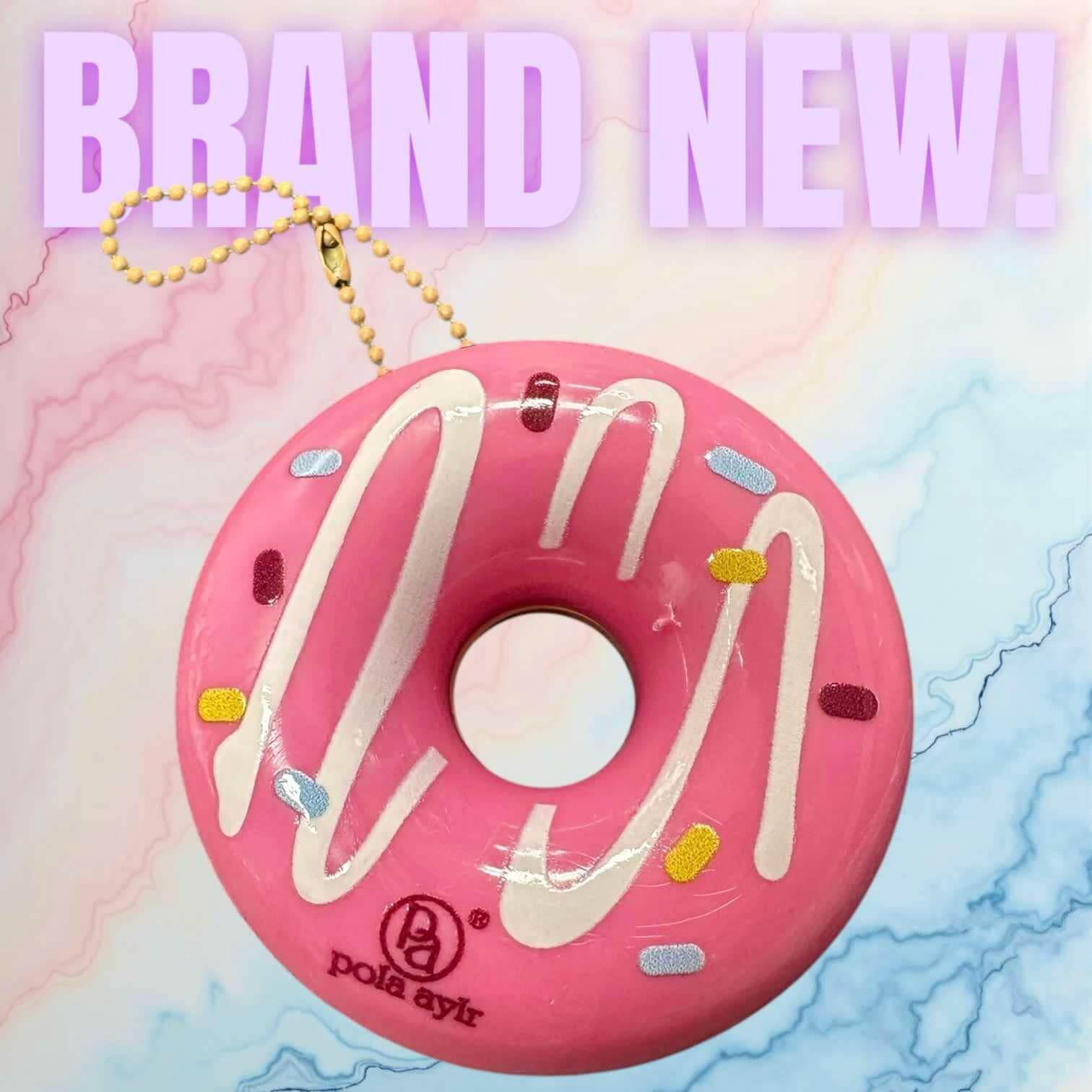 Brand new pink donut keychain lip balm from Pola aylr, perfect for smooth and nourished lips on-the-go.