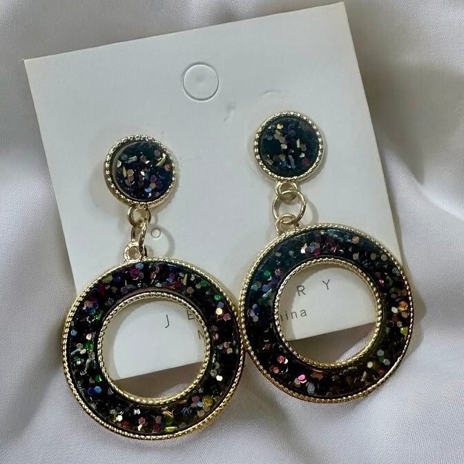 Confetti Dazzle Earrings in black, featuring sparkling glittering confetti and open circle design for playful style.