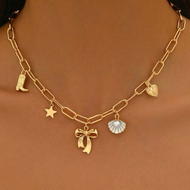 Coastal Darling Charm Necklace featuring gold tone chain and coastal-inspired charms like a star, seashell, and western boot.